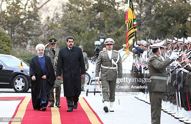 Venezuelan President Nicolas Maduro reviews an honor guard as he is welcomed by his Iranian President Hassan Rouhani , in an official arrival...