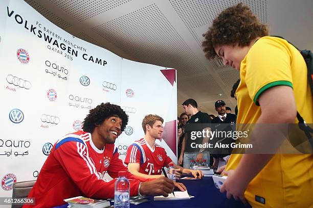 Thomas Mueller and Dante attend an autograph session at the Doha Volkswagen branch during day 2 of the Bayern Muenchen training camp at ASPIRE...