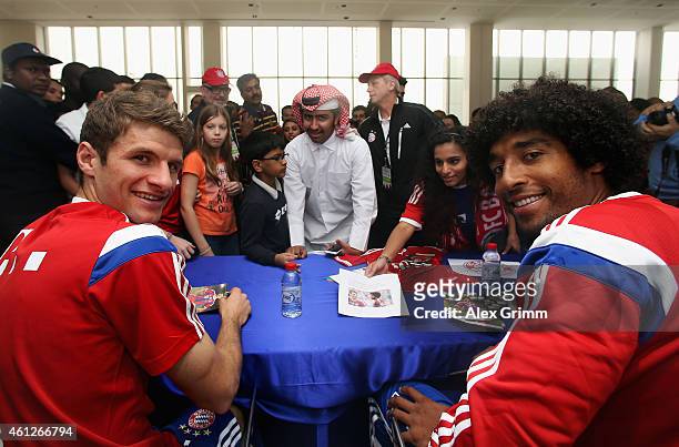 Thomas Mueller and Dante attend an autograph session at the Doha Volkswagen branch during day 2 of the Bayern Muenchen training camp at ASPIRE...