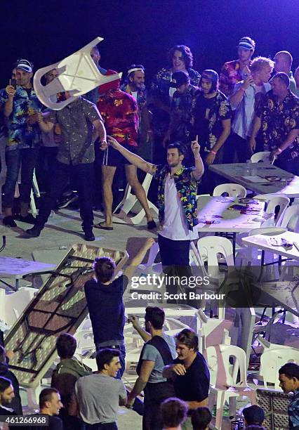 Spectators throw chairs and tables during the final between Simon The Wizard Whitlock and Mighty Michael van Gerwen during the Invitational Darts...