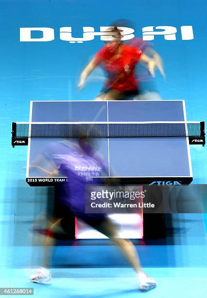 Yuling Zhu of China in action against Tianwei Feng of Singapore during the semi finals of the 2015 IFFT World Team Cup at the Al Nasr Stadium on...