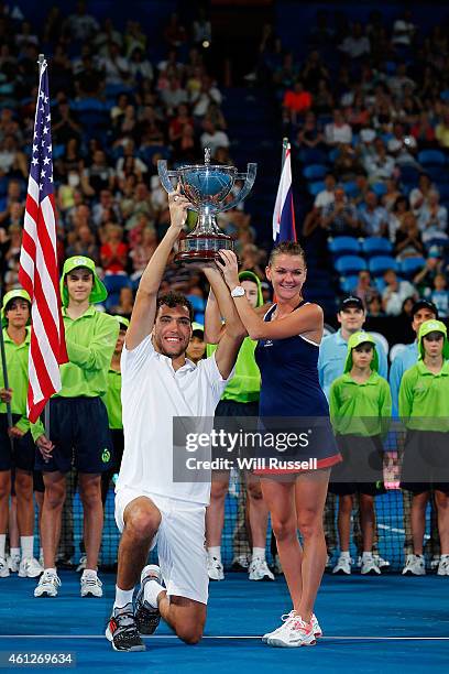 Jerzy Janowicz and Agnieszka Radwanska of Poland lift The Hopman Cup after defeating John Isner and Serena Williams of the United States in the mixed...