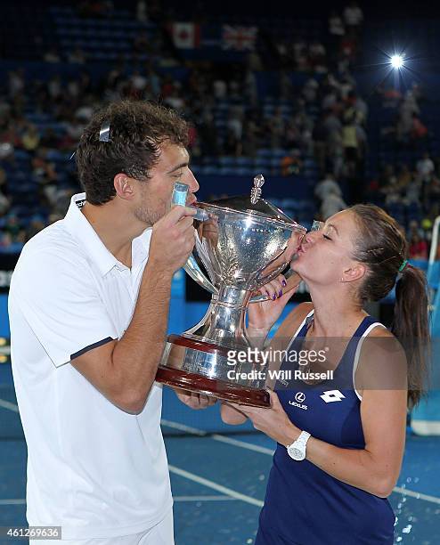 Jerzy Janowicz and Agnieszka Radwanska of Poland kiss The Hopman Cup after defeating John Isner and Serena Williams of the United States in the mixed...