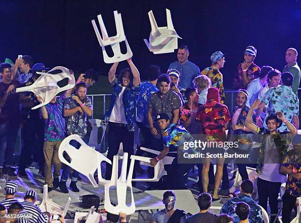 Spectators throw chairs and tables during the final between Simon The Wizard Whitlock and Mighty Michael van Gerwen during the Invitational Darts...
