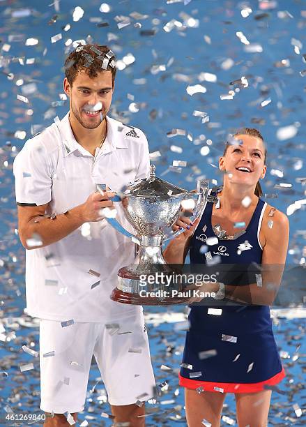 Jerzy Janowicz and Agnieszka Radwanska of Poland pose with the Hopman Cup after defeating Serena Williams and John Isner of the United States in the...
