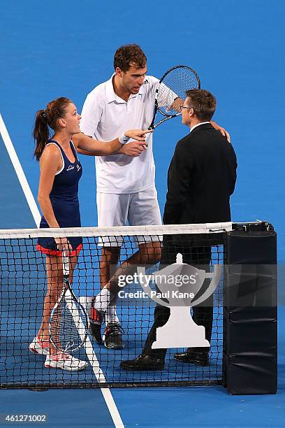 Agnieszka Radwanska and Jerzy Janowicz of Poland question a call with ITF Referee Andreas Egli in the mixed doubles final against Serena Williams and...