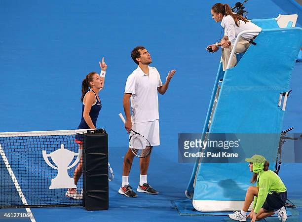 Agnieszka Radwanska and Jerzy Janowicz of Poland question a call with chair umpire Marijana Veljovic in the mixed doubles final against Serena...