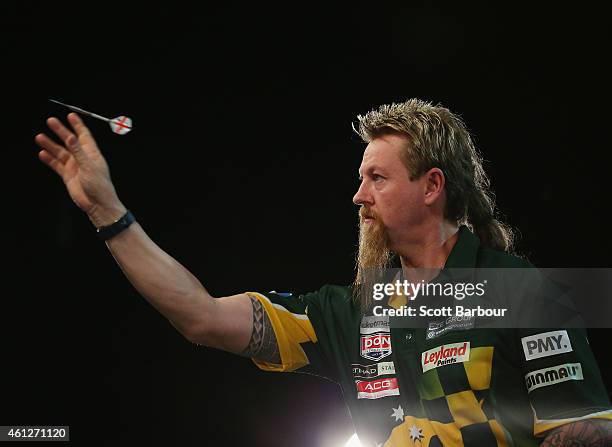 Simon Whitlock in action during the final between Simon The Wizard Whitlock and Mighty Michael van Gerwen during the Invitational Darts Challenge at...