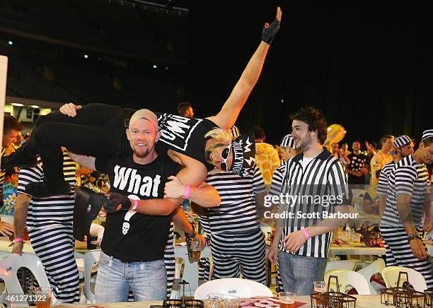 Spectators in fancy dress celebrate in the crowd during the Invitational Darts Challenge at Etihad Stadium on January 10, 2015 in Melbourne,...