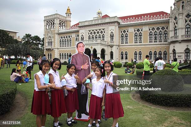 Children pose for photograph with a Prime Minister Prayut Chan-o-cha cardboard cut-out during National Children's Day at The Government House in...