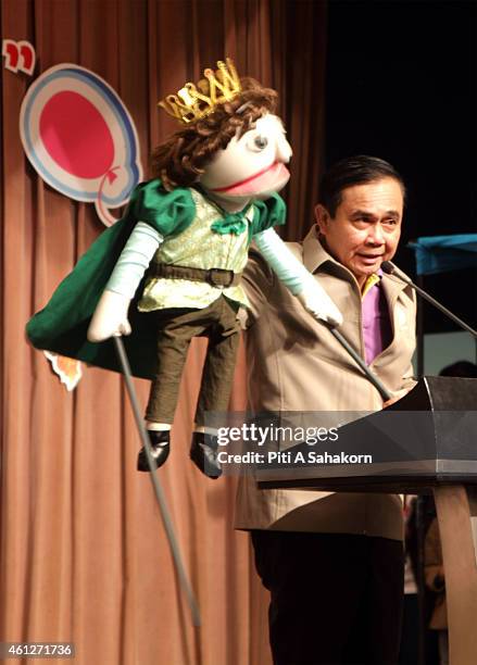 Prime Minister Prayut Chan-o-cha use a puppet to speak with children during National Children's Day at The Government House in Bangkok. The National...