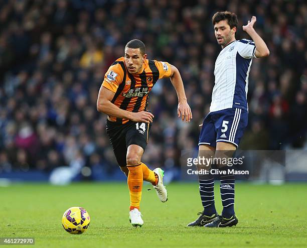 Jake Livermore of Hull City evades Claudio Yacob of West Bromwich Albion during the Barclays Premier League match between West Bromwich Albion and...