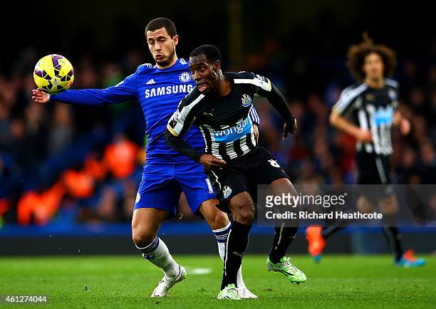 Vurnon Anita of Newcastle United battles for the ball with Eden Hazard of Chelsea during the Barclays Premier League match between Chelsea and...