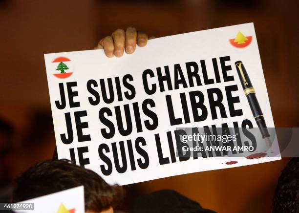 Protester holds a placard reading in French "l am Charlie, I am free, I am Lebanese" on January 10, 2015 at Samir Kassir Square in Beirut, during a...