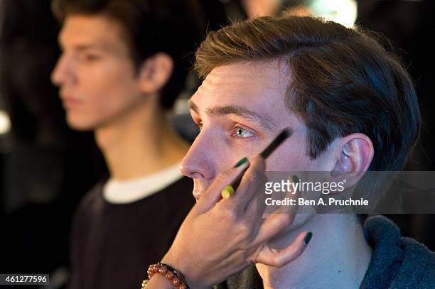 Model prepares backstage at the Hardy Amies show at the London Collections: Men AW15 at on January 10, 2015 in London, England.