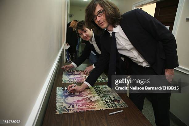 Kenneth Pattengale and Joey Ryan of The Milk Carton Kids sign autographs backstage prior to The Life & Songs of Emmylou Harris: An All Star Concert...