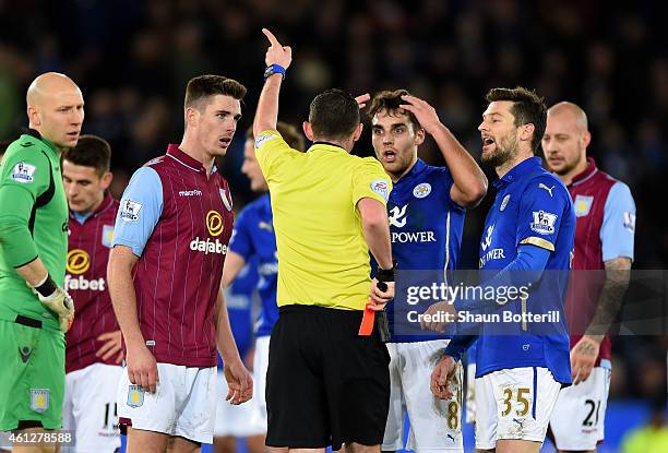 Ciaran Clark of Aston Villa and Matthew James of Leicester City react as they are shown the red card by referee Michael Oliver during the Barclays...