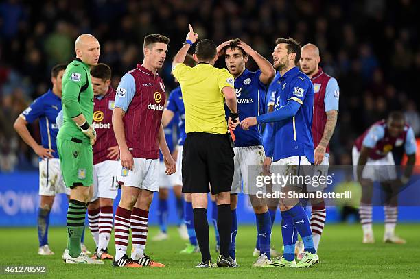 Ciaran Clark of Aston Villa and Matthew James of Leicester City react as they are shown the red card by referee Michael Oliver during the Barclays...