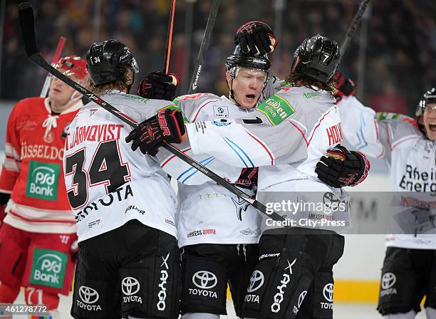 Daniel Tjernqvist, Philip Gogulla and Andreas Holmqvist of the Koelner Haien celebrate after scoring the 3:2 during the game between Duesseldorfer EG...