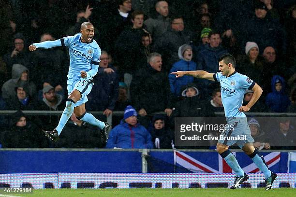 Fernandinho of Manchester City celebrates with teammate Sergio Aguero after scoring the opening goal during the Barclays Premier League match between...