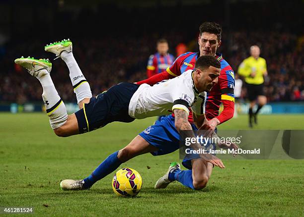 Kyle Walker of Spurs is tackled by Martin Kelly of Crystal Palace during the Barclays Premier League match between Crystal Palace and Tottenham...