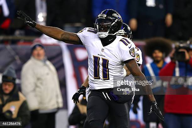Kamar Aiken of the Baltimore Ravens celebrates after scoring a touchdown in the first quarter against the New England Patriots during the 2014 AFC...