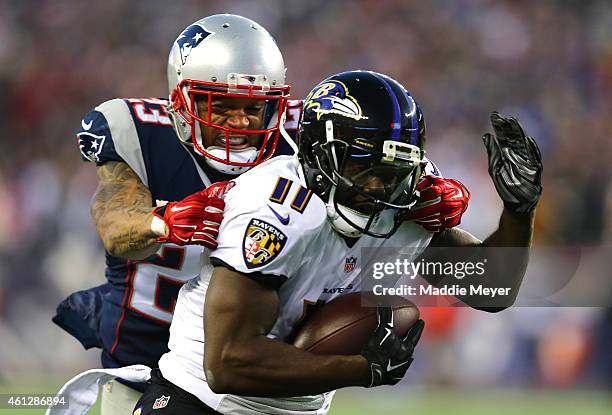 Kamar Aiken of the Baltimore Ravens catches a touchdown pass in the first quarter against Patrick Chung on the New England Patriots during the 2014...