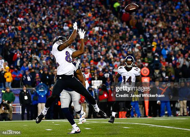 Torrey Smith of the Baltimore Ravens makes a catch in the first quarter against the New England Patriots during the 2014 AFC Divisional Playoffs game...