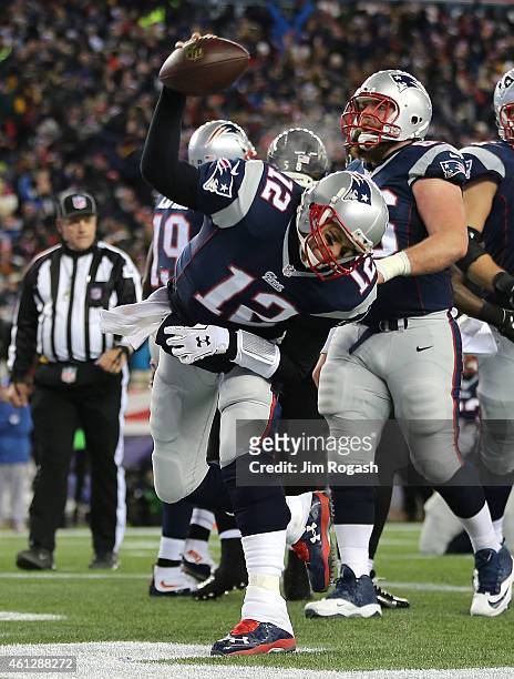 Tom Brady of the New England Patriots celebrates after rushing for a touchdown in the first quarter against the Baltimore avens during the 2014 AFC...