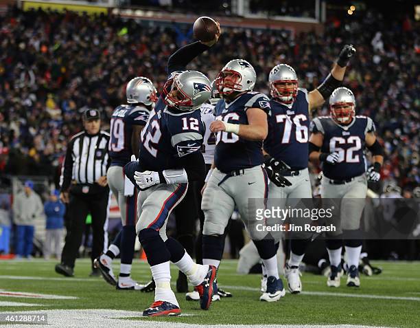 Tom Brady of the New England Patriots celebrates after rushing for a touchdown in the first quarter against the Baltimore avens during the 2014 AFC...