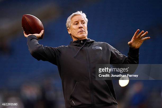 Head coach Pete Carroll of the Seattle Seahawks throws a ball during warm-ups prior to the 2015 NFC Divisional Playoff game against the Carolina...