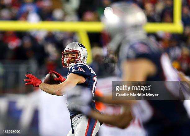 Julian Edelman of the New England Patriots throws a touchdown pass to Danny Amendola during the second half of the 2015 AFC Divisional Playoffs game...