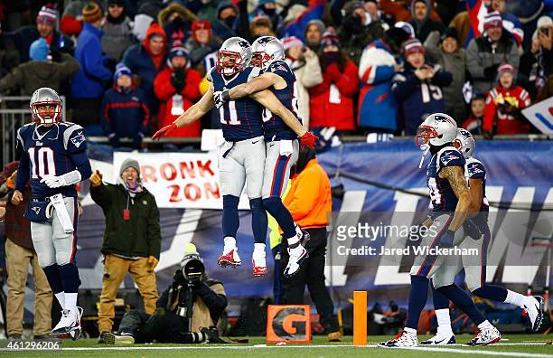 Julian Edelman and Danny Amendola of the New England Patriots reacs after a flea flicker touchdown pass during the second half of the 2015 AFC...