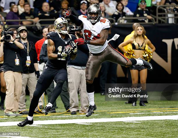 Wide receiver Robert Meachem of the New Orleans Saints catches a touchdown pass as cornerback Darrelle Revis of the Tampa Bay Buccaneers defends in...