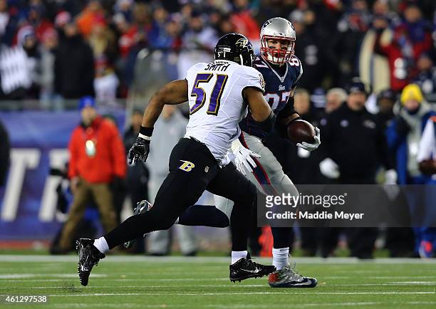 Daryl Smith of the Baltimore Ravens defends Rob Gronkowski of the New England Patriots in the first half during the 2015 AFC Divisional Playoffs game...
