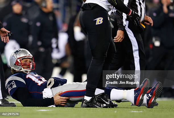 Tom Brady of the New England Patriots lies on the field after a play in the first half against the Baltimore Ravens during the 2015 AFC Divisional...