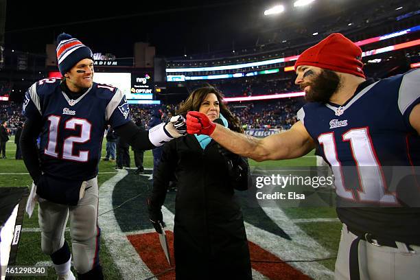 Tom Brady and Julian Edelman of the New England Patriots high five following the 2015 AFC Divisional Playoffs game against the Baltimore Ravens at...