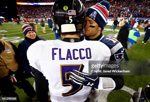 Joe Flacco of the Baltimore Ravens and Tom Brady of the New England Patriots hug following the 2015 AFC Divisional Playoffs game at Gillette Stadium...