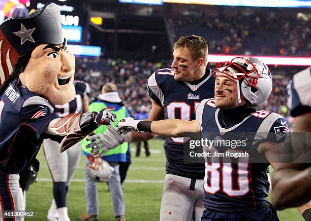 Rob Gronkowski and Danny Amendola of the New England Patriots walk off the field following the 2015 AFC Divisional Playoffs game against the...