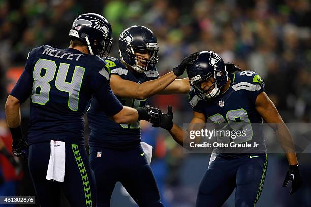 Doug Baldwin of the Seattle Seahawks celebrates with Cooper Helfet and Jermaine Kearse after catching a 16 yard touchdown pass from Russell Wilson in...