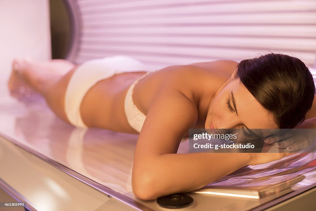 Beauty on tanning bed.