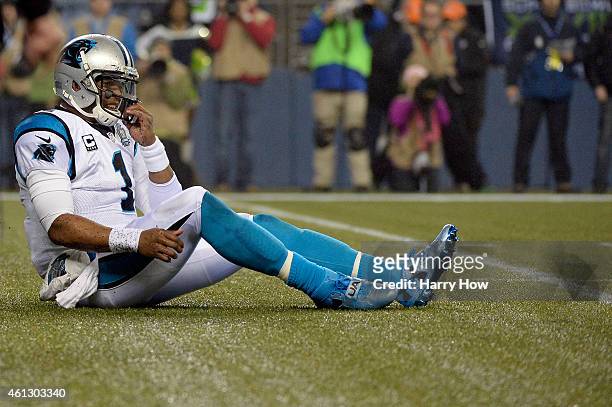 Cam Newton of the Carolina Panthers reacts after a third down loss in the first quarter against the Seattle Seahawks during the 2015 NFC Divisional...