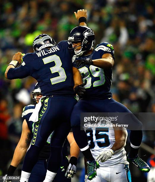 Doug Baldwin of the Seattle Seahawks celebrates with Russell Wilson after catching a 16 yard touchdown pass in the first quarter against the Carolina...