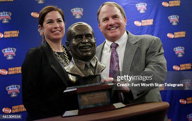 Texas Christian head coach Gary Patterson, with his wife Kelsey Patterson, receives the Eddie Robinson Coach of the Year Award at the Renaissance...