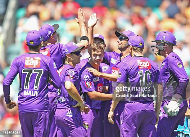 Cameron Boyce of the Hurricanes is congratulated by his teammates after dismissing Michael Carberry of the Scorchers during the Big Bash League match...