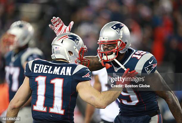 Patriots wide receiver Julian Edelman celebrates with teammate Brandon LaFell after LaFell's touchdown in the fourth quarter of the AFC Divisional...