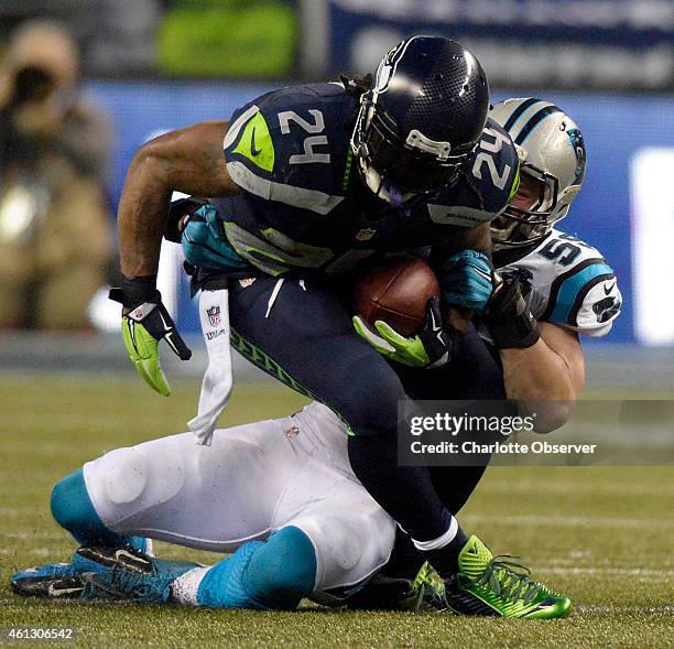 Carolina Panthers linebacker Luke Kuechly brings down Seattle Seahawks running back Marshawn Lynch in the second quarter in NFC Divisional Playoff...