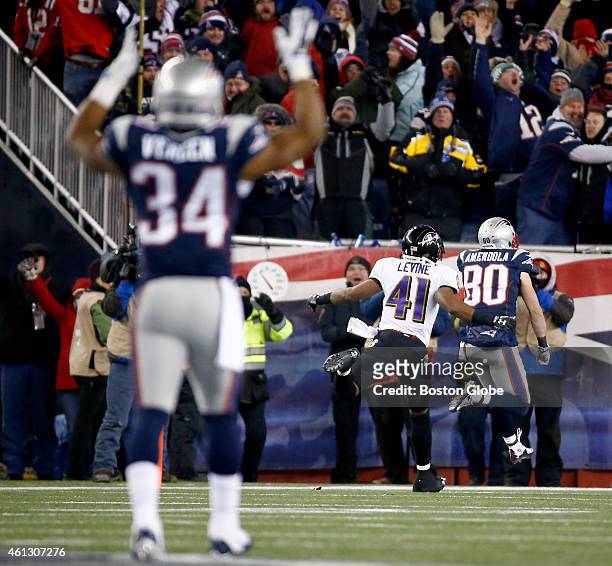 New England Patriots' Shane Vereen signals a touchdown as teammate Danny Amendola beats the Baltimore Ravens' Anthony Levine after Amendola's 51-yard...