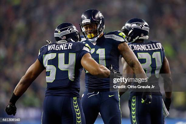 Kam Chancellor of the Seattle Seahawks celebrates with Bobby Wagner after scoring a 90 yard touchdown off of an interception in the fourth quarter...