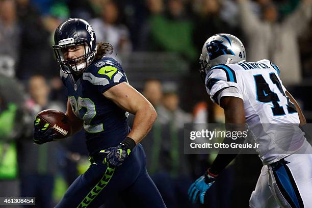 Luke Willson of the Seattle Seahawks runs the ball for a 25 yard touchdown in the fourth quarter against the Carolina Panthers during the 2015 NFC...